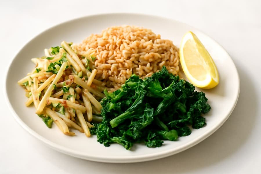 Plate with banana stem salad, brown rice, and greens