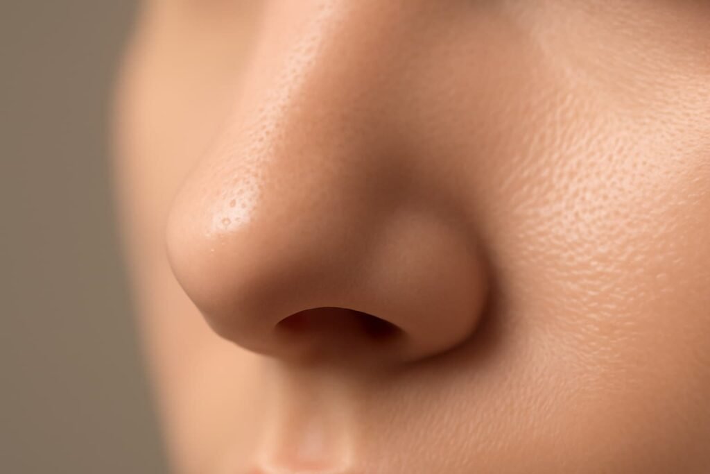 Consistent BHA helps keep blackheads at bay: Close‑up of refined nose pores after pore‑clearing skincare.
